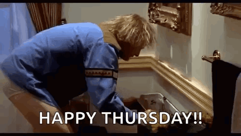 A Man In A Blue Jacket Is Cleaning A Trash Can In A Bathroom With The Words `` Happy Thursday ! '' GIF