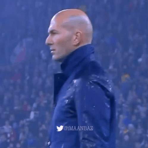 A Man In A Blue Jacket Is Covered In Water GIF