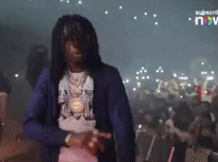 A Man In A Blue Jacket Is Dancing In A Crowd GIF