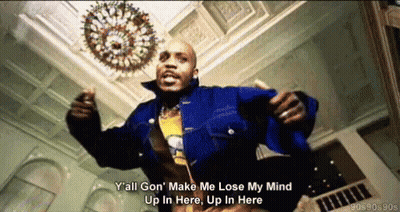 A Man In A Blue Jacket Is Dancing In A Room With A Chandelier In The Background GIF