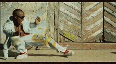 A Man In A Blue Jacket Is Doing A Trick On The Ground GIF