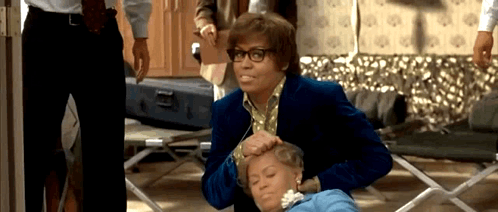 A Man In A Blue Jacket Is Putting A Woman 'S Head On A Table . GIF