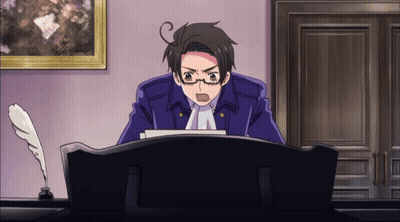 A Man In A Blue Jacket Is Sitting At A Desk With A Pen In Front Of Him GIF