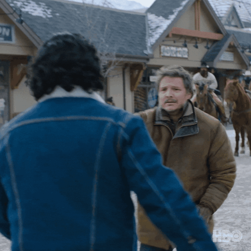 A Man In A Blue Jacket Is Standing Next To Another Man In A Brown Jacket GIF