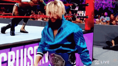 A Man In A Blue Jacket Is Walking Out Of A Wrestling Ring GIF