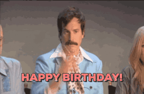 A Man In A Blue Jacket Says Happy Birthday In Red Letters GIF