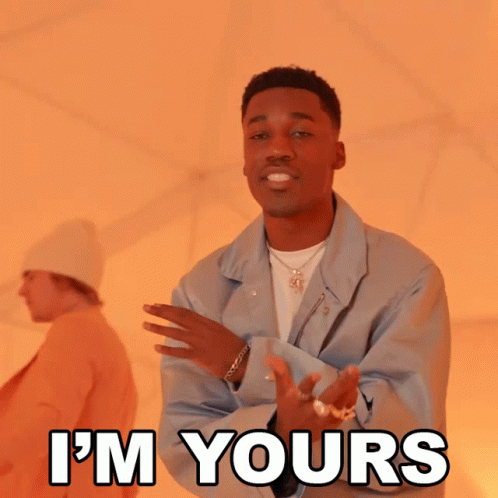 A Man In A Blue Jacket Says " I 'M Yours " In Front Of Another Man GIF