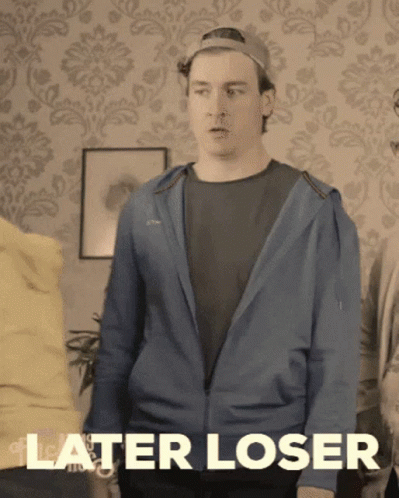 A Man In A Blue Jacket Says " Later Loser " In Front Of A Patterned Wall GIF
