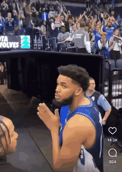 A Man In A Blue Jersey With The Number 1 On It Stands In Front Of A Crowd GIF