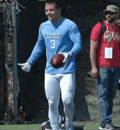 A Man In A Blue Jersey With The Number 3 On It Is Holding A Football . GIF