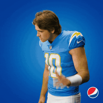 A Man In A Blue Jersey With The Number 9 On It Holds His Hand To His Ear GIF