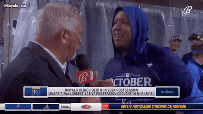 A Man In A Blue October Shirt Is Being Interviewed By A Man In A Suit GIF