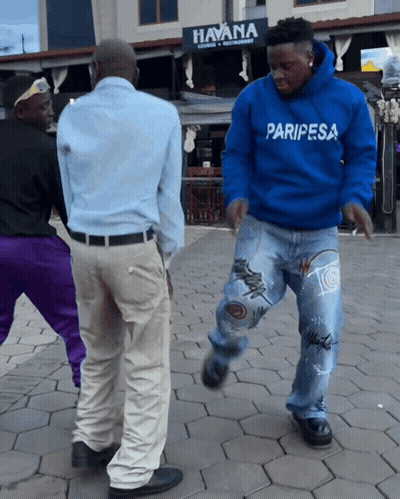 A Man In A Blue Paripesa Sweatshirt Dancing GIF