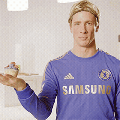 A Man In A Blue Samsung Shirt Holds A Cupcake GIF
