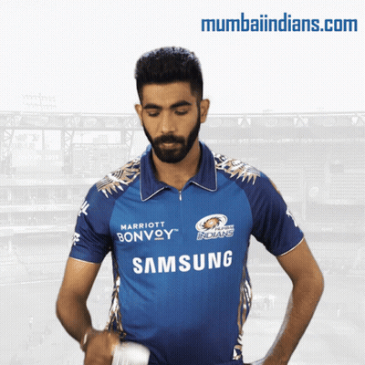 A Man In A Blue Samsung Shirt Stands In Front Of A Stadium GIF