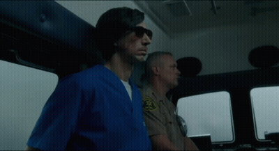 A Man In A Blue Scrub Is Standing Next To A Man In A Tan Uniform With A Badge That Says Sheriff GIF
