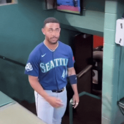 A Man In A Blue Seattle Jersey Stands In A Stairwell GIF