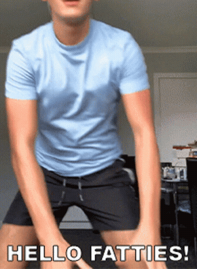 A Man In A Blue Shirt And Black Shorts Is Dancing With The Words Hello Fatties Below Him GIF