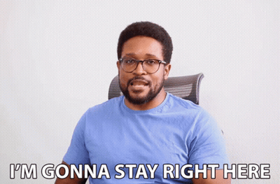 A Man In A Blue Shirt And Glasses Says I 'M Gonna Stay Right Here GIF