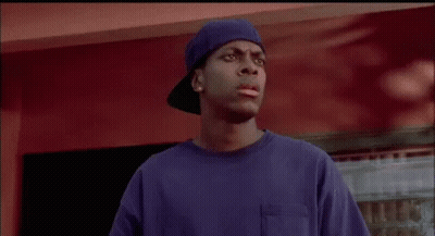 A Man In A Blue Shirt And Hat Is Standing In Front Of A Red Wall And Talking About Going To Cry In The Car . GIF