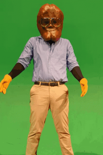 A Man In A Blue Shirt And Khaki Pants Is Wearing A Cookie Mask And Sunglasses GIF