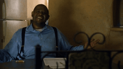 A Man In A Blue Shirt And Suspenders Is Smiling GIF
