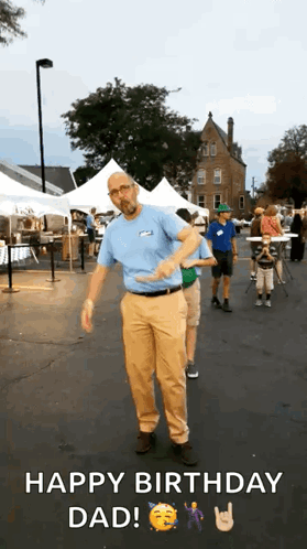 A Man In A Blue Shirt And Tan Pants Is Dancing In A Parking Lot While Someone Says Happy Birthday Dad . GIF