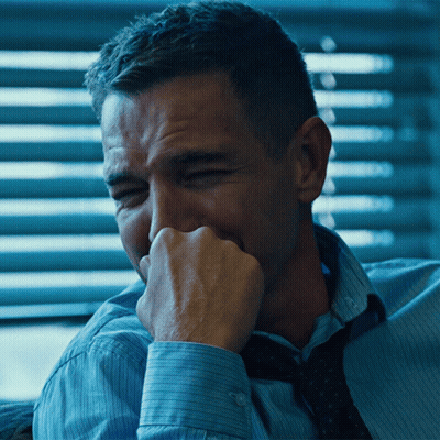 A Man In A Blue Shirt And Tie Is Covering His Mouth GIF