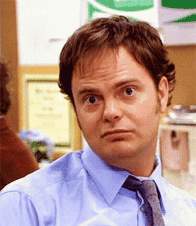 A Man In A Blue Shirt And Tie Is Looking At The Camera GIF