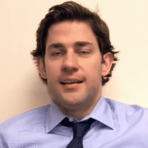 A Man In A Blue Shirt And Tie Is Making A Face . GIF