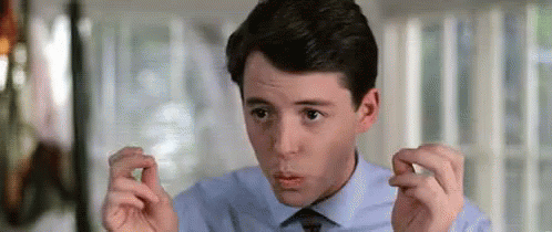 A Man In A Blue Shirt And Tie Is Making A Funny Face . GIF