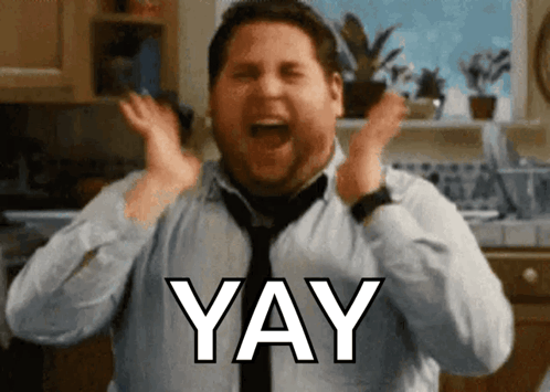A Man In A Blue Shirt And Tie Is Screaming With The Word Yay Above His Head GIF
