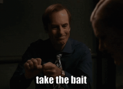 A Man In A Blue Shirt And Tie Is Smiling And Saying Take The Bait GIF