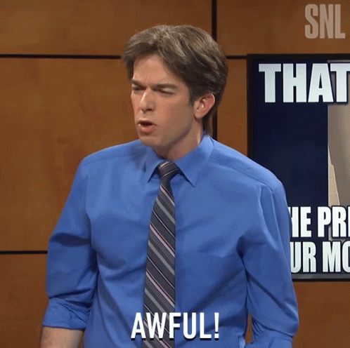 A Man In A Blue Shirt And Tie Says Awful In Front Of A Sign That Says That GIF