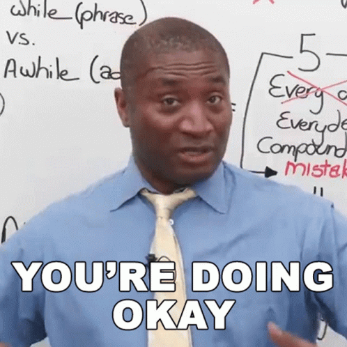 A Man In A Blue Shirt And Tie Says " You 'Re Doing Okay " In Front Of A White Board GIF