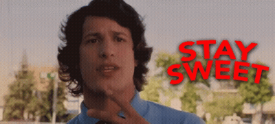 A Man In A Blue Shirt And Tie Stands In Front Of A Sign That Says Stay Sweet GIF