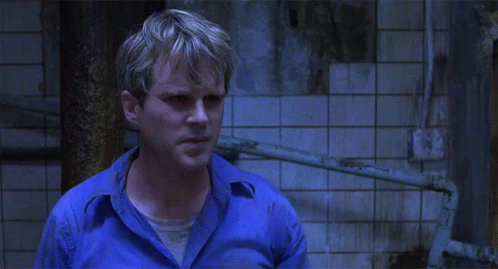 A Man In A Blue Shirt Asks " What Does That Mean " GIF