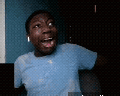 A Man In A Blue Shirt Has His Mouth Open GIF