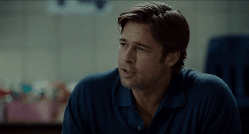 A Man In A Blue Shirt Has The Word What Written On The Screen GIF