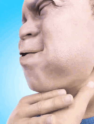 A Man In A Blue Shirt Holds His Hand To His Throat GIF