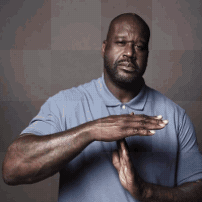 A Man In A Blue Shirt Holds His Hands Together In Front Of His Chest GIF