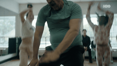 A Man In A Blue Shirt Is Dancing In A Room With A Hbo Logo On The Bottom GIF