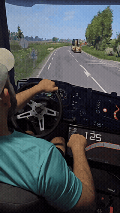 A Man In A Blue Shirt Is Driving A Truck With The Number 125 Displayed On The Dashboard GIF