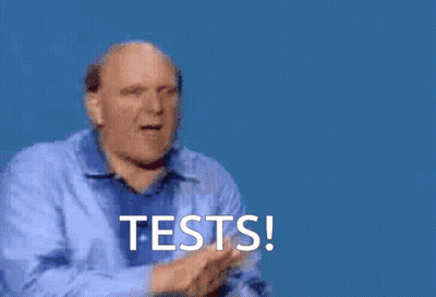 A Man In A Blue Shirt Is Giving A High Five With The Words Tests Written Below Him GIF