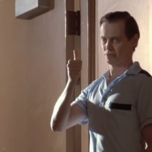 A Man In A Blue Shirt Is Giving A Thumbs Up Sign GIF