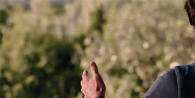 A Man In A Blue Shirt Is Giving A Thumbs Up Sign GIF