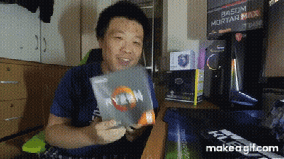 A Man In A Blue Shirt Is Holding A Box Of Ryzen GIF