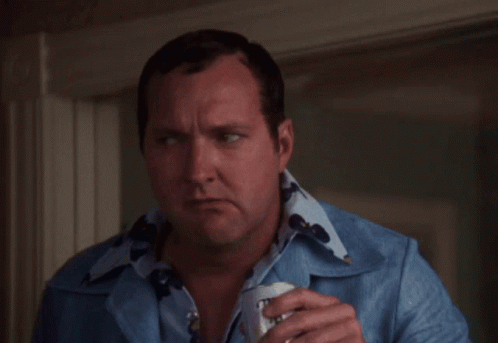 A Man In A Blue Shirt Is Holding A Can Of Bud Light Beer GIF