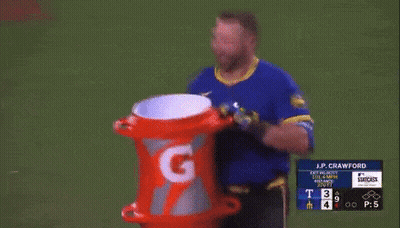 A Man In A Blue Shirt Is Holding A Gatorade Can GIF