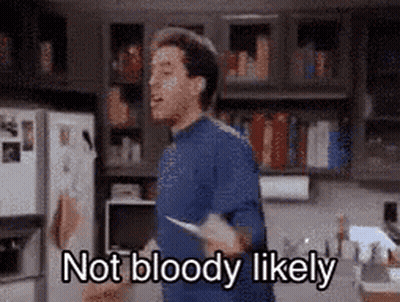 A Man In A Blue Shirt Is Holding A Knife In A Kitchen And Says `` Not Bloody Likely '' . GIF